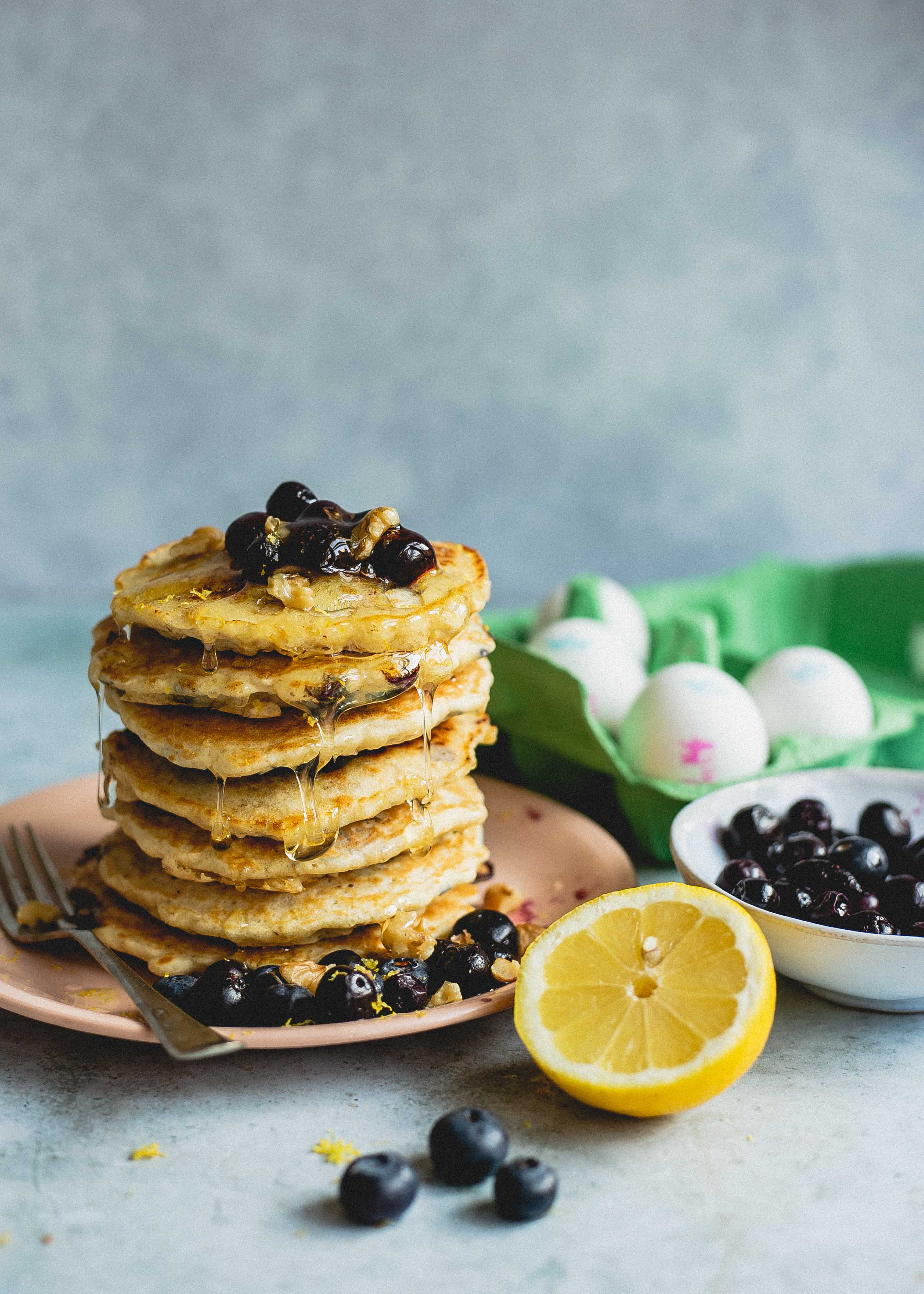 FODMAP friendly blueberry pancakes dripping with maple syrup