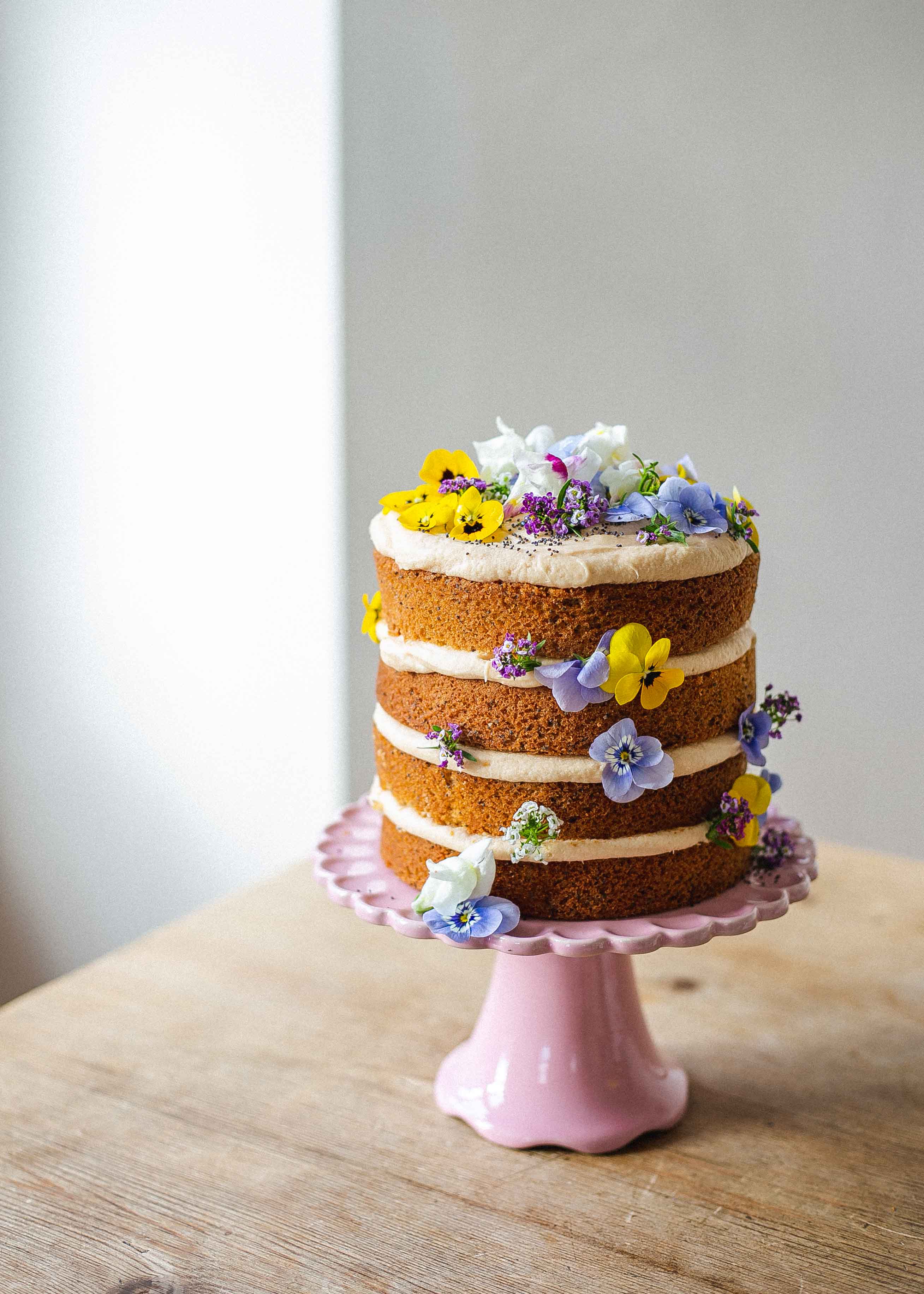 Low FODMAP earl grey, lemon and poppy seed mother's day cake with edible flowers